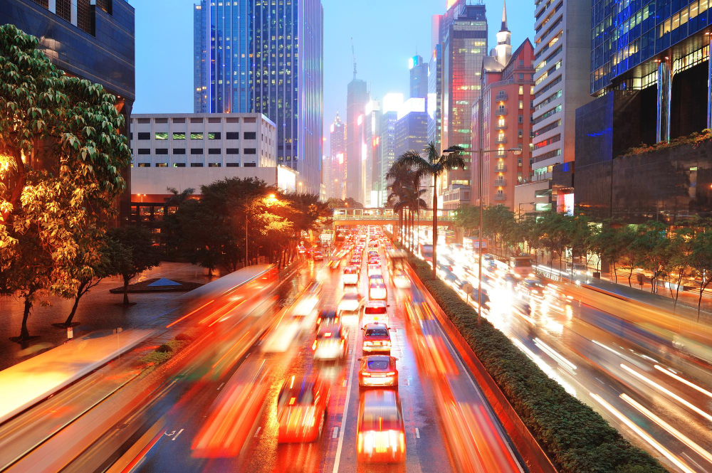 hong-kong-street-with-busy-traffic-skyscraper-office-dusk